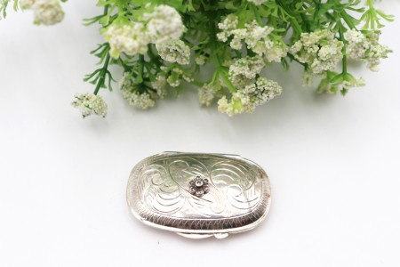 Caixa de comprimidos em prata com gravados e pedra em forma de flor